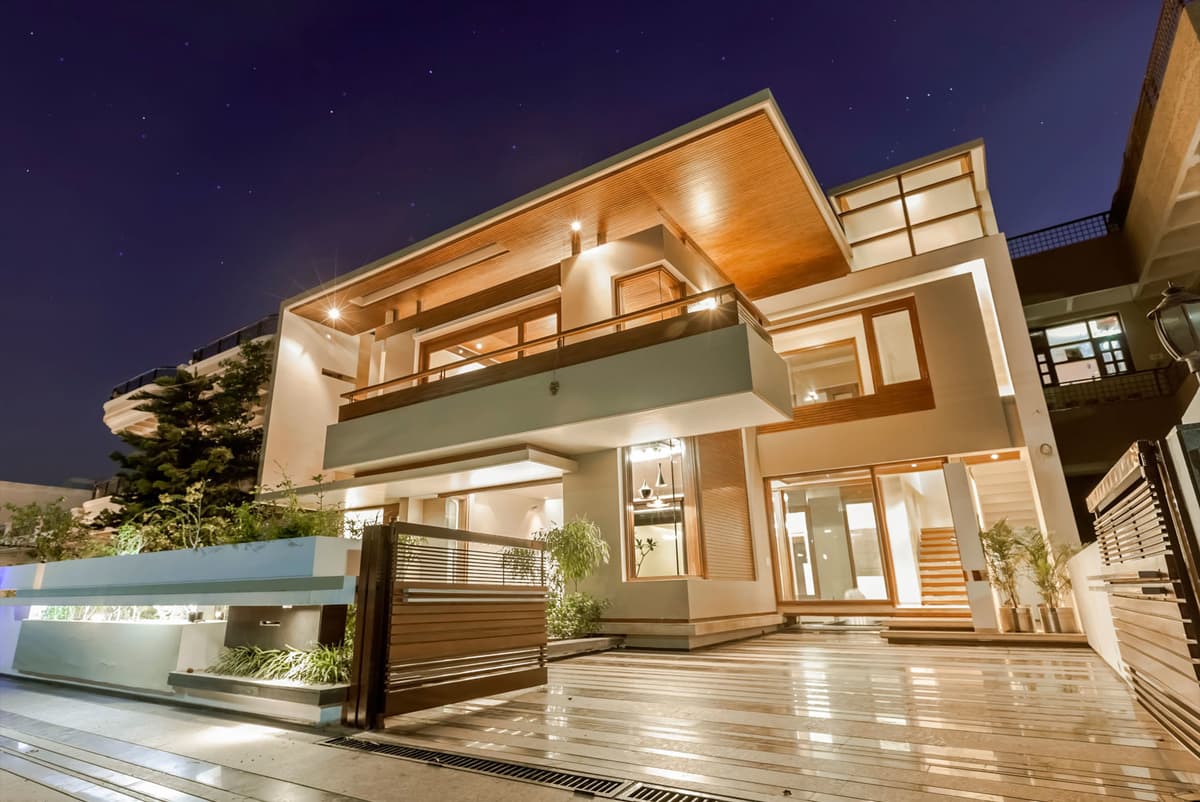 Exterior view of a two story residence with LED lights at a night scene